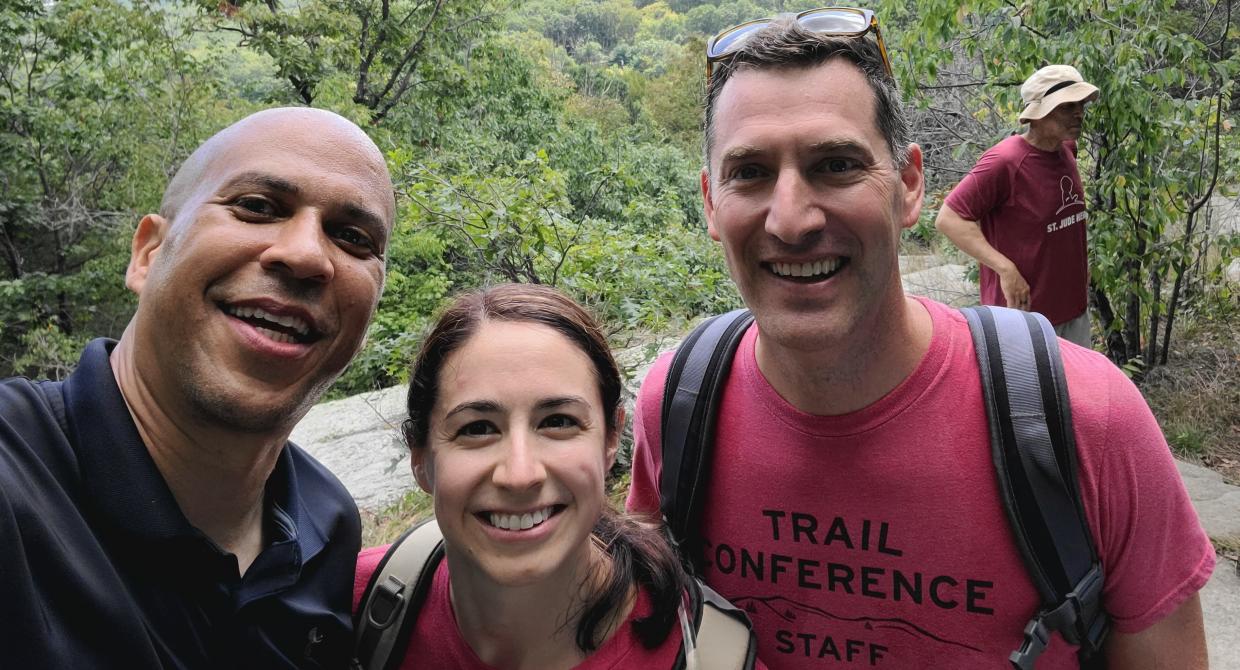 Senator Cory Booker poses with the Trail Conference's Mary Perro and Joshua Howard during a hike at Pyramid Mountain. Photo credit: New York-New Jersey Trail Conference