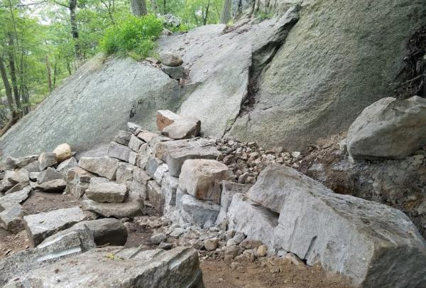 The Megalithic Trail Crew is building a crib wall staircase as part of the Appalachian Trail reroute on Bear Mountain. Photo by Eduardo Gill.