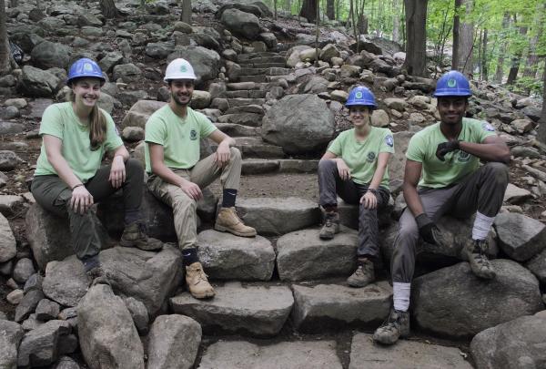 Sweet Water Trail Crew proudly sitting on their stone steps built on the Ramapo Valley County Reservation Vista Loop. Photo by Brayden Donnelly.