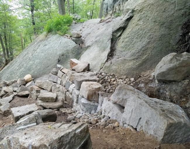 The Megalithic Trail Crew is building a crib wall staircase as part of the Appalachian Trail reroute on Bear Mountain. Photo by Eduardo Gill.