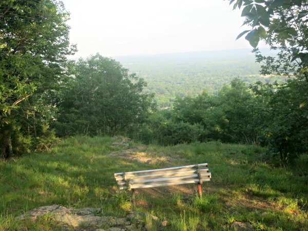 The bench at the summit of Pequannock Knob and the east-facing view from the summit. Photo by Daniel Chazin.
