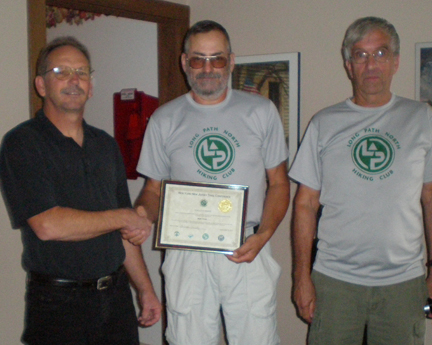 Mark Traver, center, gets award from Andy Garrison (l) and Clarence Putnam, Long Path chairs.