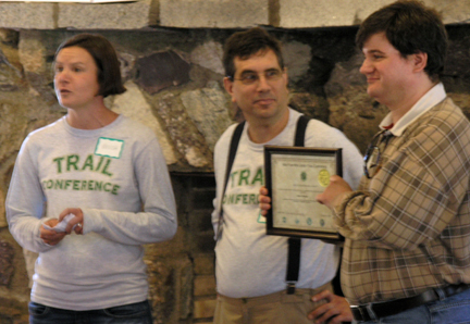 Volunteer Arthur Gardineer (r) gets award from Trail Conference staffers Melissa Bean and Gary Willick.