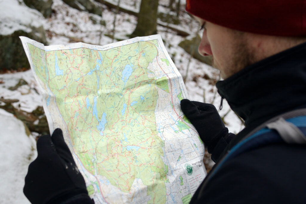 Winter hiker reviewing NYNJTC trail map, Harriman SP - Photo by Krysti Sabins