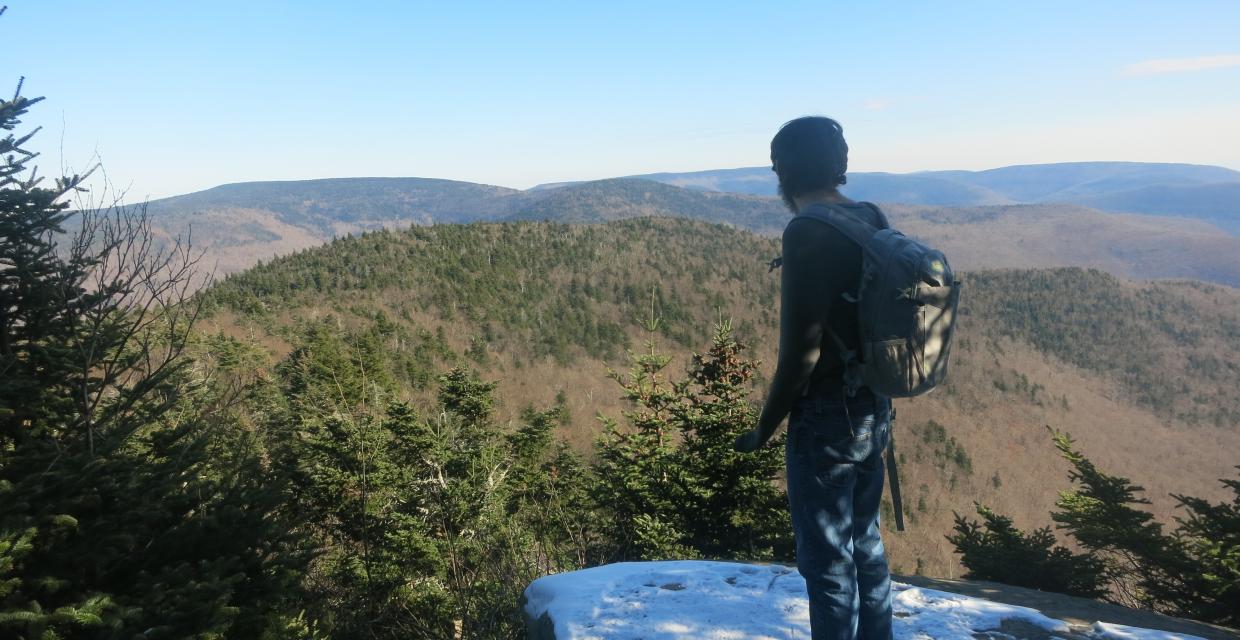 A hiker taking in the view from the Buck Ridge Lookout - Photo by Daniel Chazin